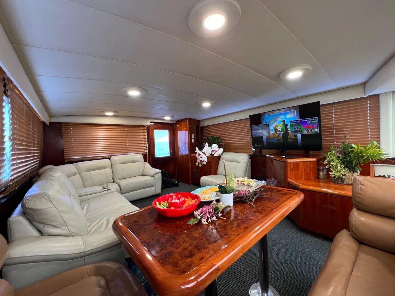 Main salon of the 55-foot Hatteras yacht with leather seating and dining table